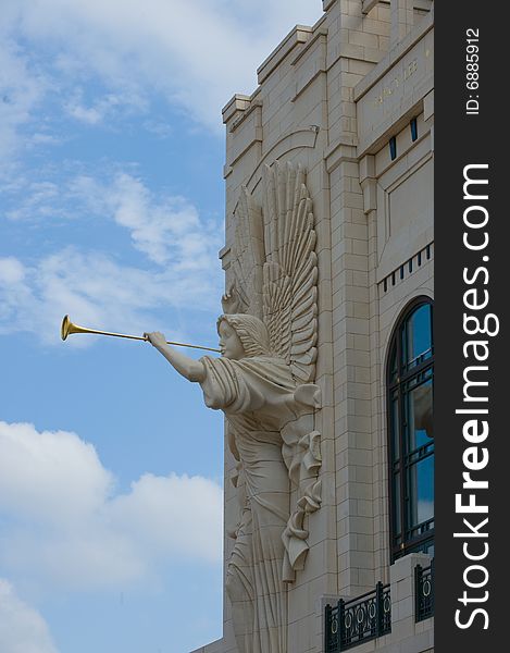 An image of an angel on a building with a horn