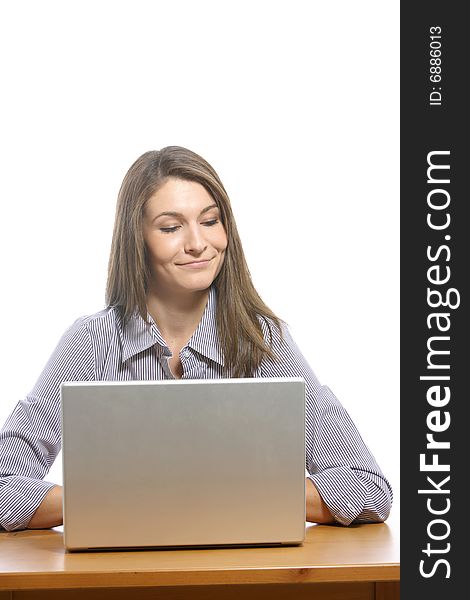 A business woman on her laptop at a desk in the studio