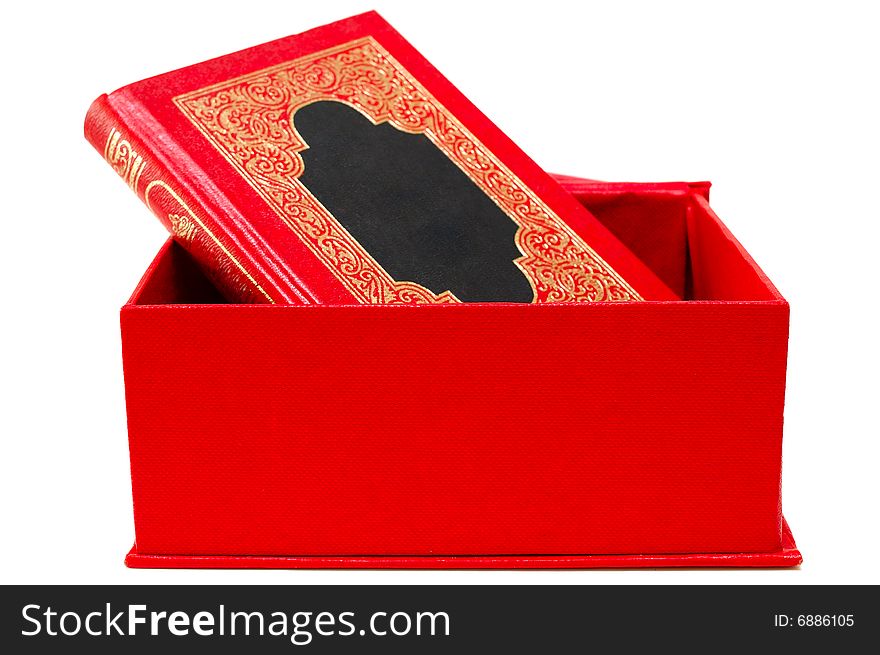 Red cover book with golden ornament in red box.