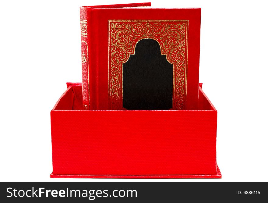 Red cover book with golden decoration (ornament) in red cardboard box on isolated background. Red cover book with golden decoration (ornament) in red cardboard box on isolated background.