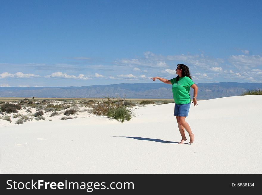 Female pointing at White Sands National Monument in New Mexico. Female pointing at White Sands National Monument in New Mexico.