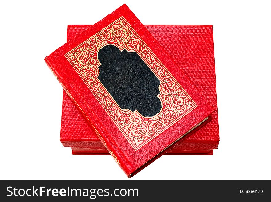 Red cover book with golden decoration (ornament) in red cardboard box on isolated background. Red cover book with golden decoration (ornament) in red cardboard box on isolated background.