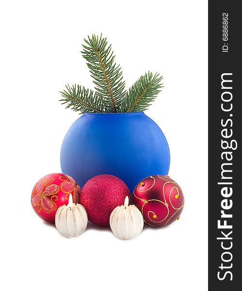 Decorative burning candles with New Year's spheres and green branch of on white background with blue vase. Decorative burning candles with New Year's spheres and green branch of on white background with blue vase