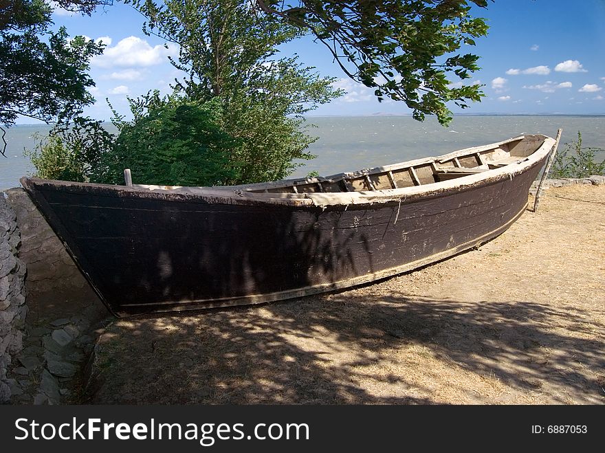 Old fishing boat in a tree shade. Old fishing boat in a tree shade