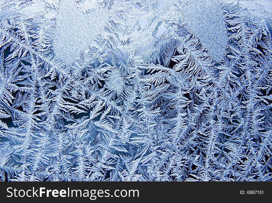 Small blue ice crystals on a window. Small blue ice crystals on a window