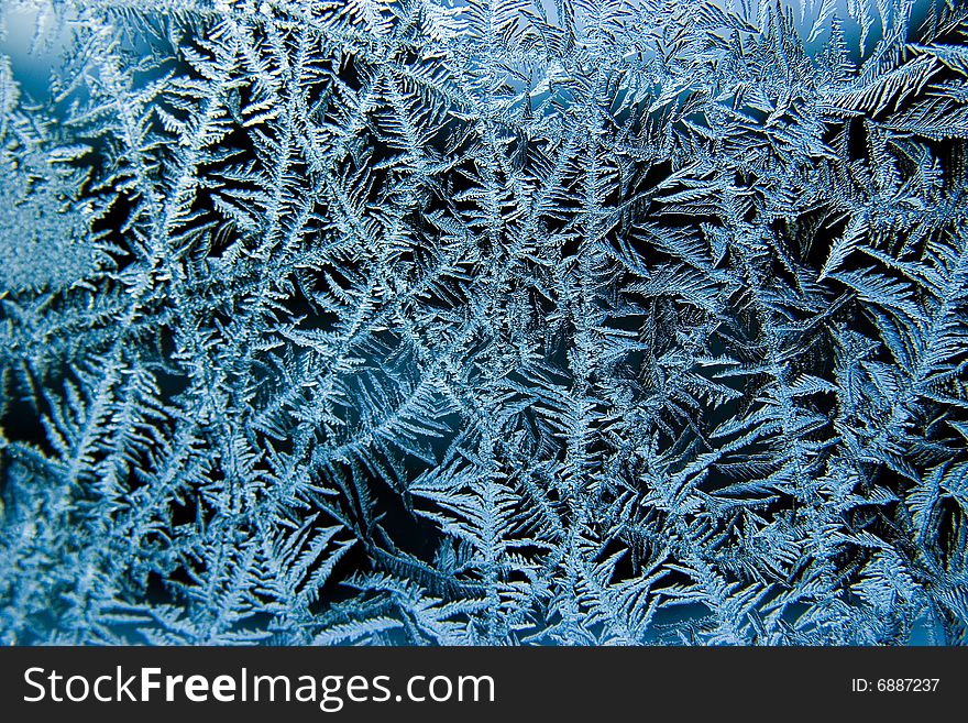 Small blue ice crystals on a window. Small blue ice crystals on a window