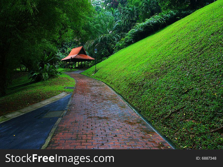 A red pavilion at the end of a redbrick path. A red pavilion at the end of a redbrick path