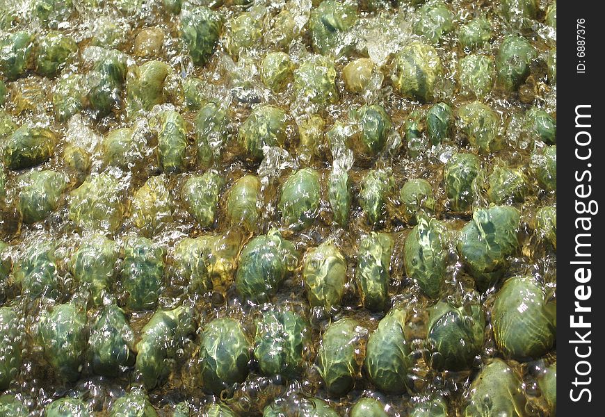 Water on green pebbles fountain