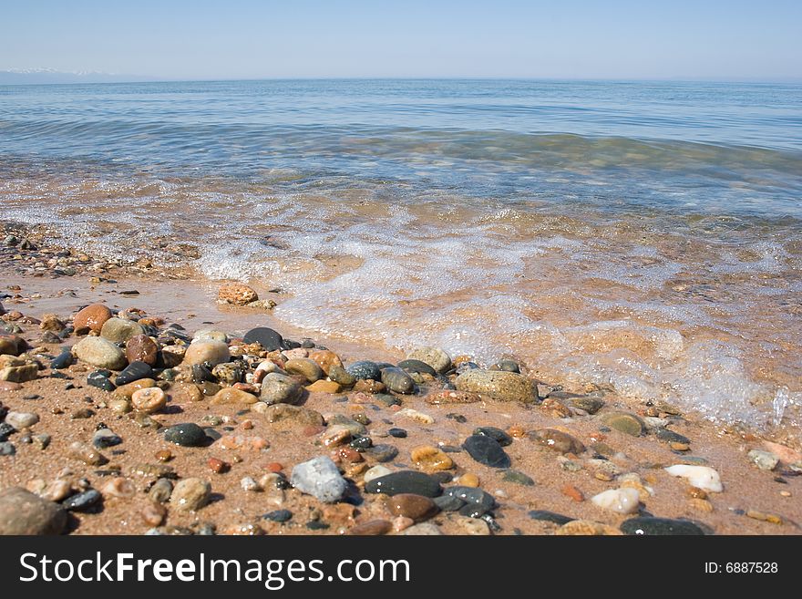 Baikal shore with sky and stones. Baikal shore with sky and stones