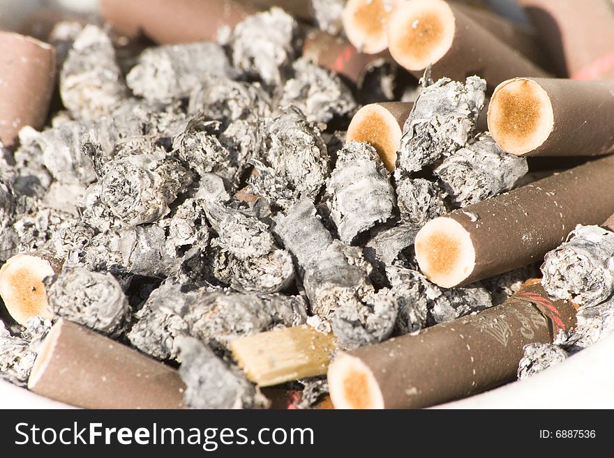 Old brown cigarettes in the ashtray. Old brown cigarettes in the ashtray