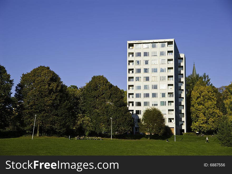 A building next to the park. The trees got color from the atumn. A building next to the park. The trees got color from the atumn.