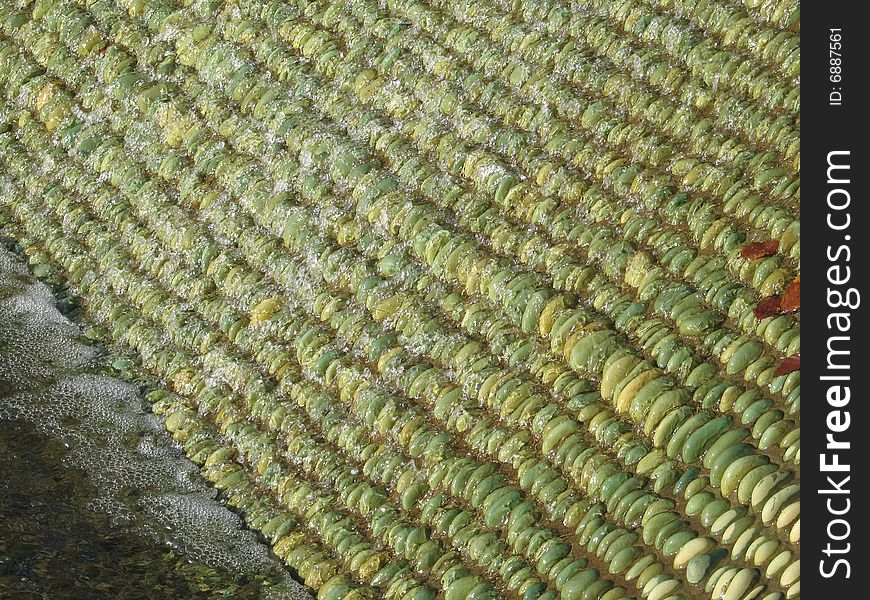 Water on green pebbles fountain