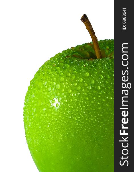 Green apple with multiple water droplets, more concentrated on the top. Freshly washed. Portrait format.