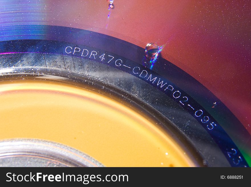 DVD disk with several water droplets on the surface. DVD disk with several water droplets on the surface