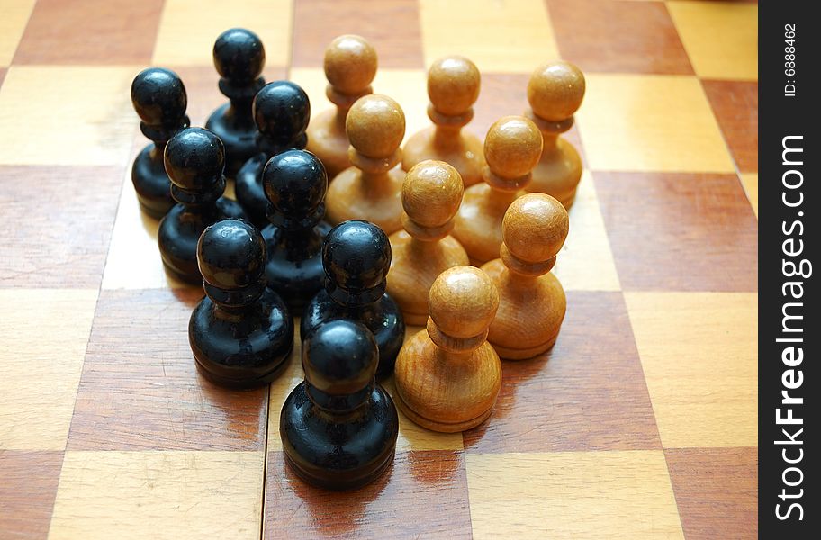 Vintage black and white pawns on chess board. Vintage black and white pawns on chess board