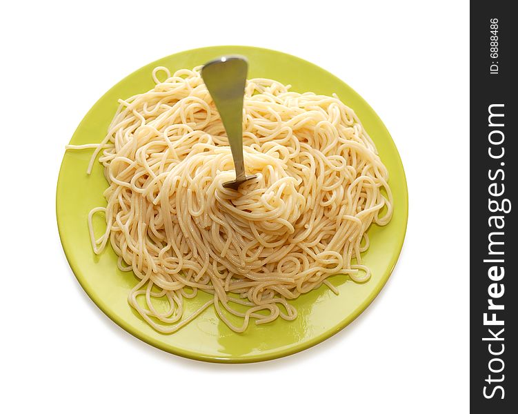 Spaghetti around fork on the green plate