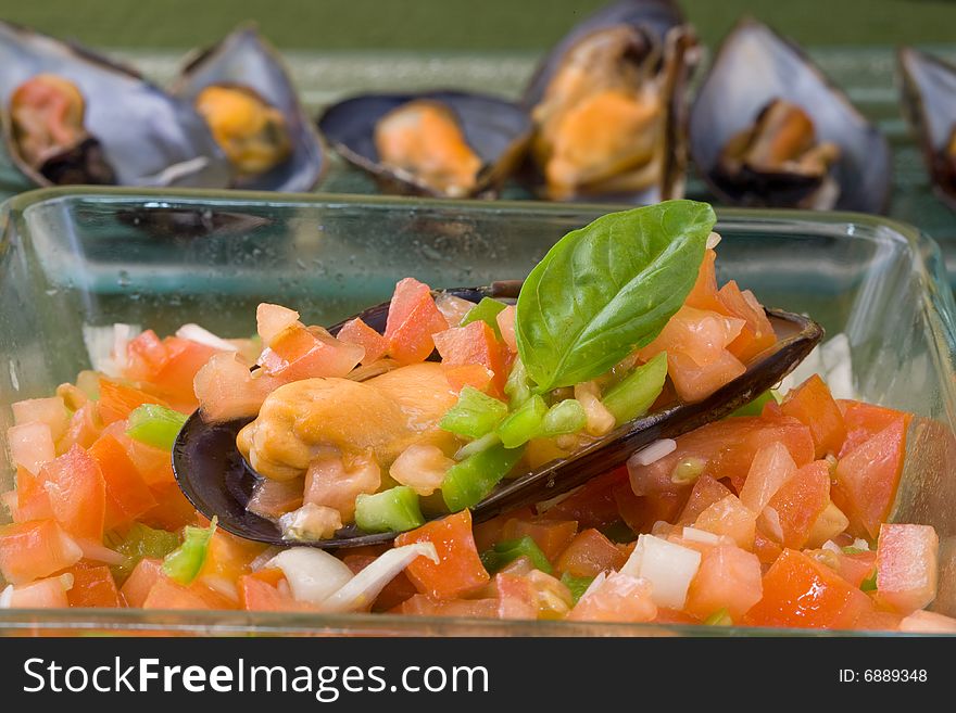 Mussel filled with tomato onions and green pepper on platter
