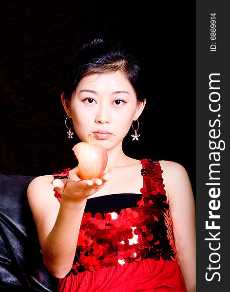 Asian female model holding bitten red apple. Asian female model holding bitten red apple