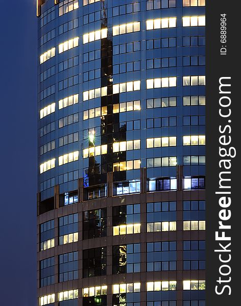 Blue mirrored wall of scyscraper with lights in Moscow (Russia)