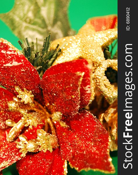 Detail of a christmas decoration with a red flower and a golden star