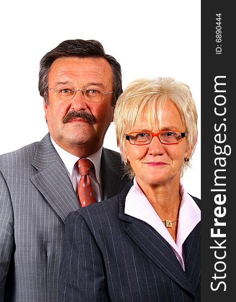 A senior business couple in suits in their 50s and 60s. Isolated over white. A senior business couple in suits in their 50s and 60s. Isolated over white.