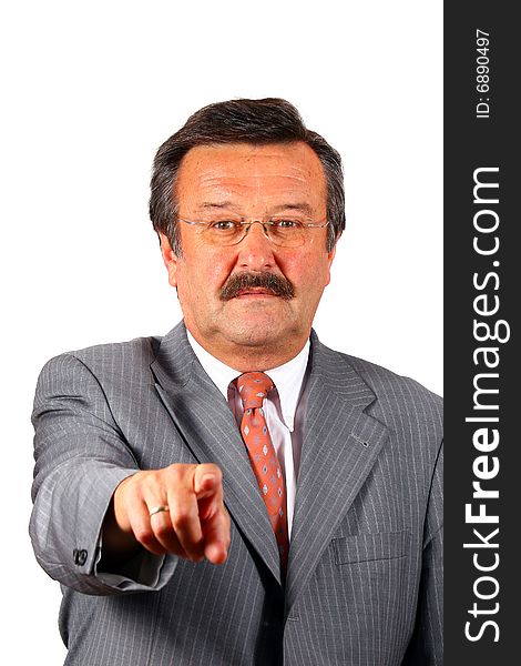 A businessman in his sixties with glasses a suit and a mustache pointing at you Focus on his face. Isolated over white. A businessman in his sixties with glasses a suit and a mustache pointing at you Focus on his face. Isolated over white.