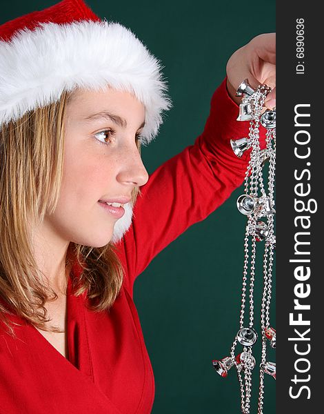 Beautiful teenager wearing a red shirt and christmas hat. Beautiful teenager wearing a red shirt and christmas hat