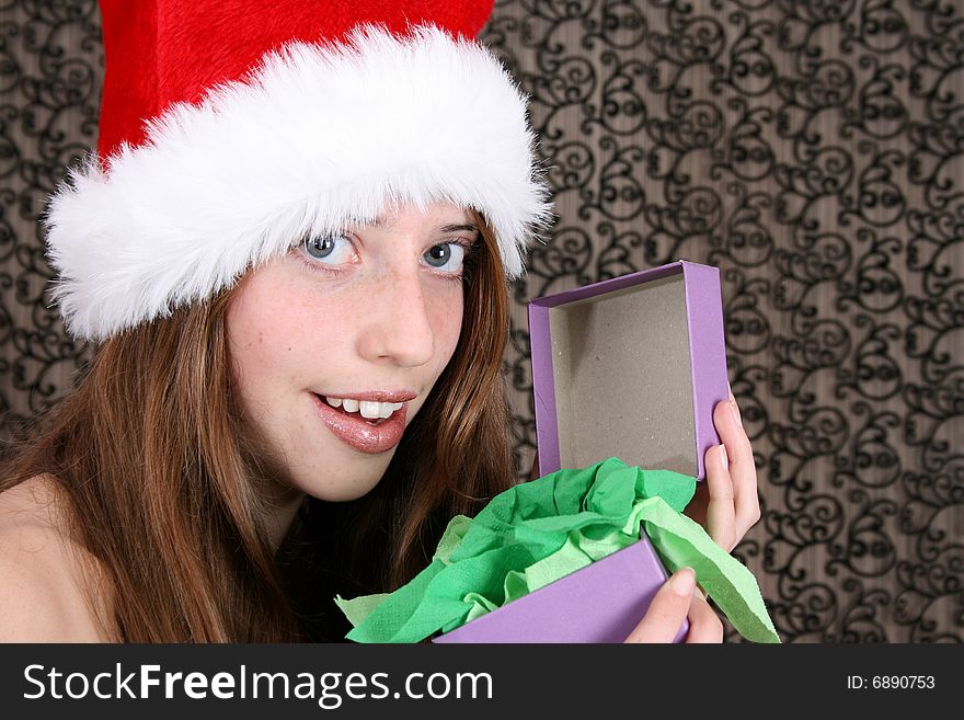 Brunette Teenager wearing a fluffy christmas hat. Brunette Teenager wearing a fluffy christmas hat