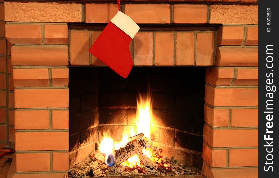 Close-up of brick fireplace with hanging red cristmas sock. Close-up of brick fireplace with hanging red cristmas sock