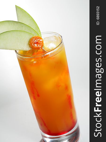 Alcoholic Cocktail made of Liqueur, Rum, Pineapple Juice and Grenadine Syrup Served with Apple Slice. Isolated on White Background. Alcoholic Cocktail made of Liqueur, Rum, Pineapple Juice and Grenadine Syrup Served with Apple Slice. Isolated on White Background