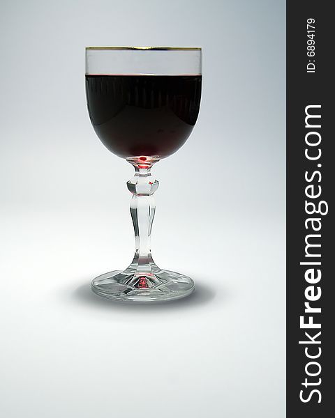 A glass of red wine on white simple background. A glass of red wine on white simple background