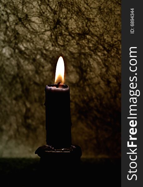 Candle against a dark background