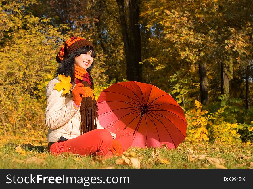 Young woman on the autumn leaf