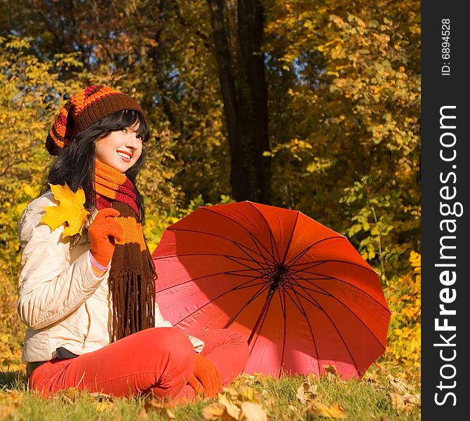 Young woman on the autumn leaf