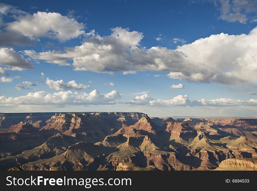 Grand Canyon during the day with a blue sky and clouds