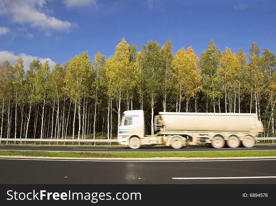 The car for cement transportation moves on road. The car for cement transportation moves on road.