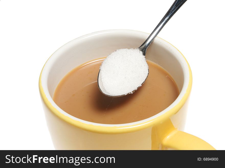 Closeup of a mug of coffee and spoonful of sugar. Closeup of a mug of coffee and spoonful of sugar