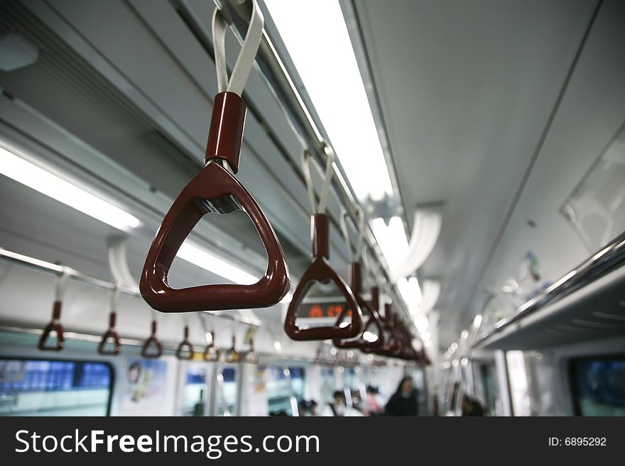 Brown Handles Hanging from Ceiling of Underground Subway Car. Brown Handles Hanging from Ceiling of Underground Subway Car