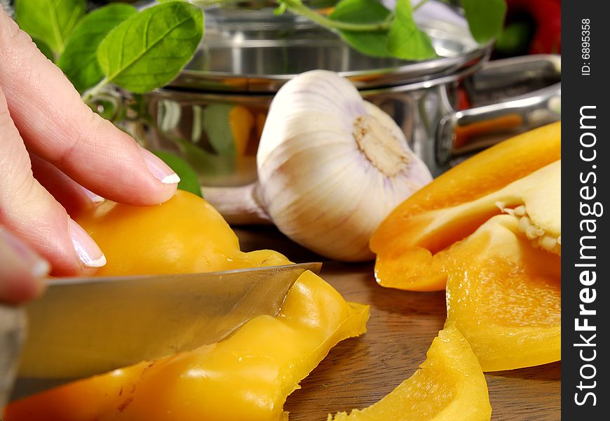Cutting yellow pepper on a kitchen board