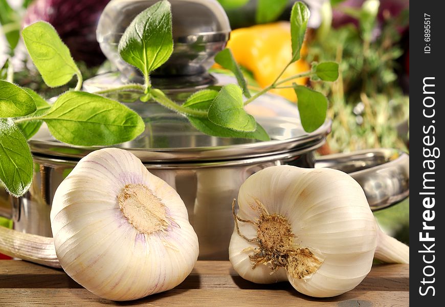 Garlic and thyme in front of a cooking pot