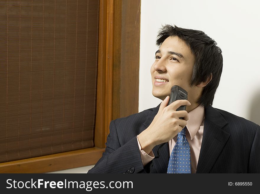 Smiling man in a suit shaving. Horizontally framed photo. Smiling man in a suit shaving. Horizontally framed photo.