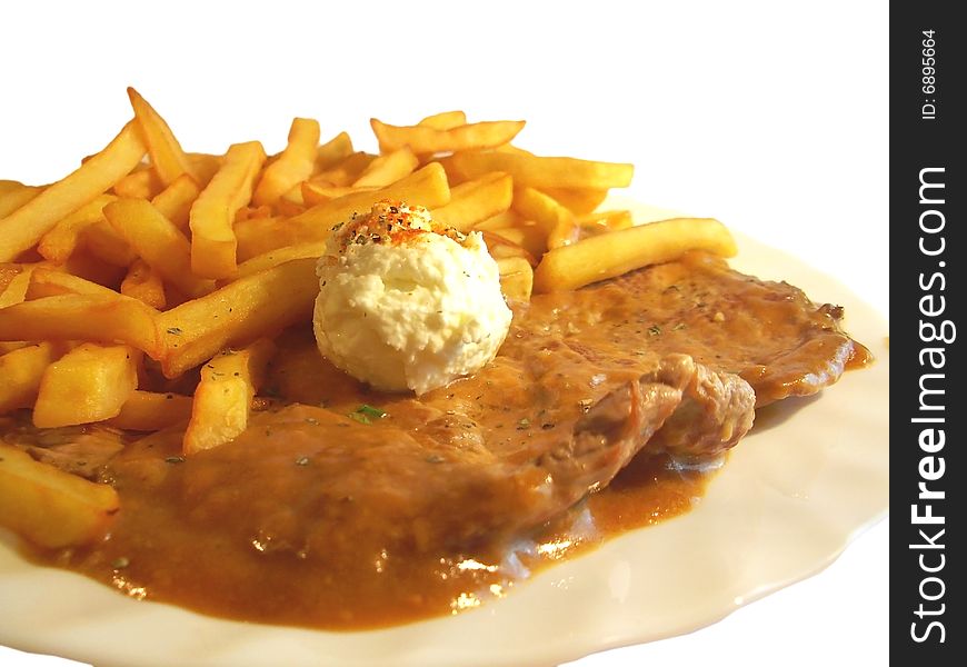 Steak with french fries and cream on the plate isolated. Steak with french fries and cream on the plate isolated