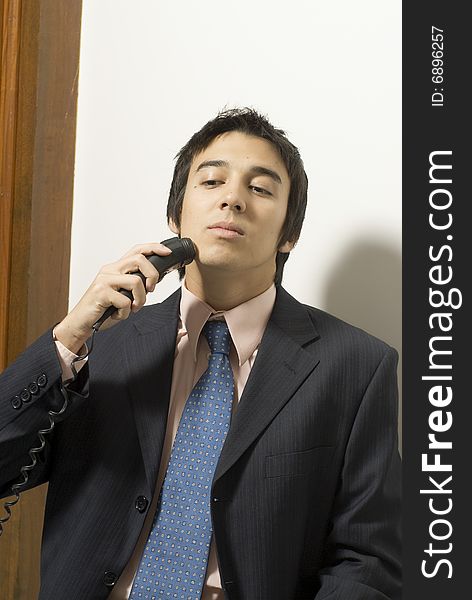 Man in a suit shaving. Vertically framed photo. Man in a suit shaving. Vertically framed photo.