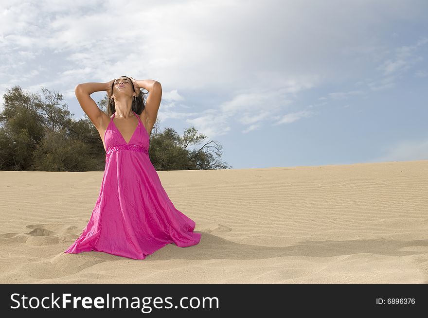 Young Sexy Woman In The Sand Near The Sea