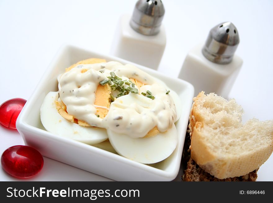 A fresh salad of eggs with some bread