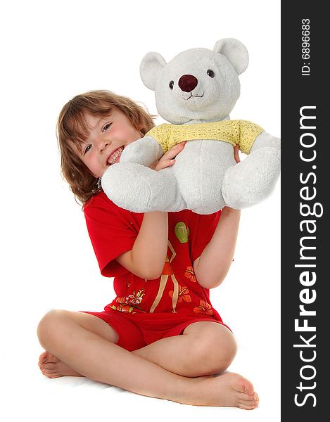 Young girl sitting on the floor with teddy bears