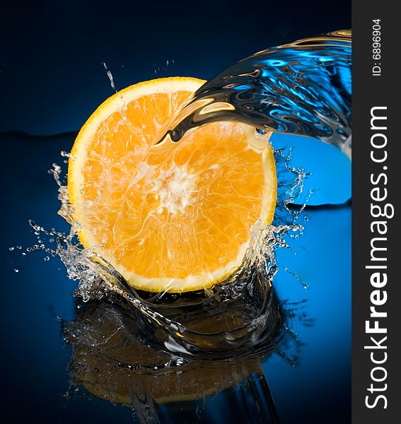 Orange with water splash, blue water. Orange with water splash, blue water