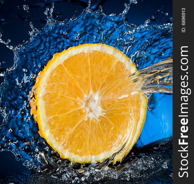 Orange with water splash, blue water. Orange with water splash, blue water