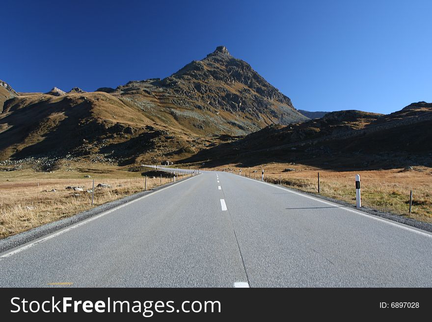 Alpen high mountains road with a car. Alpen high mountains road with a car