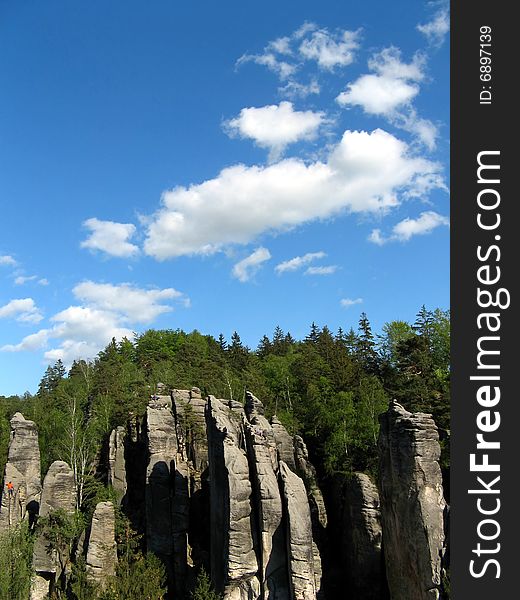 Blue sky and white clouds over forest and rock towers. Blue sky and white clouds over forest and rock towers